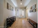 Spacious foyer with tile flooring, decorative art and a welcoming entrance at 16368 W Cortez St, Surprise, AZ 85388