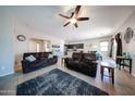 Open-concept living room seamlessly connects to the dining and kitchen areas, creating an inviting space at 16368 W Cortez St, Surprise, AZ 85388