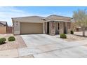 Well-maintained single-story home featuring a two-car garage and low-maintenance landscaping at 18854 W Poinsettia Dr, Surprise, AZ 85388