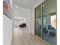 Bright hallway with tile flooring leading to the living area and a glass slider to the patio at 18854 W Poinsettia Dr, Surprise, AZ 85388
