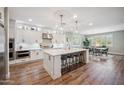 Bright, modern kitchen with a large island, pendant lighting, stainless steel appliances, and a dining area at 20198 E Rosa Rd, Queen Creek, AZ 85142