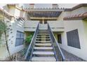 Charming two-story condo featuring an exterior staircase leading to the upper-level units with a covered patio area at 2333 E Southern Ave # 2033, Tempe, AZ 85282