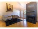 Cozy living room with a fireplace and French doors leading to the outdoors, creating a warm and inviting space at 2333 E Southern Ave # 2033, Tempe, AZ 85282