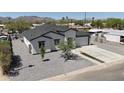 An aerial view shows this well-maintained home with a xeriscaped yard, modern design, and mountain views at 2790 W Cholla St, Apache Junction, AZ 85120