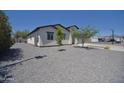 The backyard boasts a xeriscaped design, mature trees, and a clean, modern aesthetic, enhancing the outdoor space at 2790 W Cholla St, Apache Junction, AZ 85120