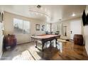 Spacious game room featuring a pool table, custom lighting, and unique concrete flooring at 3147 E Vallejo Dr, Gilbert, AZ 85298