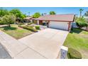 Well-maintained home with a spacious driveway, lush front yard and mature landscaping at 333 E Caribbean Ln, Phoenix, AZ 85022