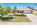 Well-maintained home featuring mature landscaping, green grass and a spacious front yard at 333 E Caribbean Ln, Phoenix, AZ 85022