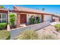 Charming home featuring a brick-accented entrance, desert landscaping, and a red tile roof at 333 E Caribbean Ln, Phoenix, AZ 85022
