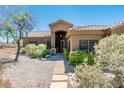 Charming home with well-maintained landscaping, a stone walkway, and a welcoming front entrance at 33823 N 2Nd St, Phoenix, AZ 85085