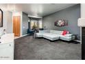 Modern living room featuring carpet flooring, a large sectional sofa, and a bay window at 33823 N 2Nd St, Phoenix, AZ 85085