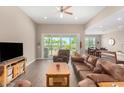 Inviting living room showcasing wood floors, large windows, and access to a serene outdoor space at 37456 W Vera Cruz Dr, Maricopa, AZ 85138
