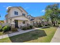 Well-maintained home featuring a covered porch, stone accents, and tidy front lawn landscaping at 3863 S Posse Trl, Gilbert, AZ 85297