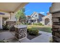 Charming home in a community featuring covered porches with stone pillars and verdant landscaping at 3863 S Posse Trl, Gilbert, AZ 85297