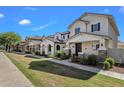Pleasant street view showcasing homes with covered entries, stone pillars, and well-kept lawns at 3863 S Posse Trl, Gilbert, AZ 85297