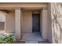 Covered porch with tan pillars provides a sheltered entrance to the home's front door at 40759 W Bravo Dr, Maricopa, AZ 85138