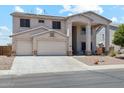 Charming two-story home featuring a two-car garage and welcoming front porch with decorative columns at 4118 N 304Th Ln, Buckeye, AZ 85396