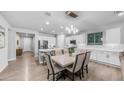 Bright kitchen area featuring white cabinets, light countertops, and a cozy dining space at 4341 W Pelotazo Way, San Tan Valley, AZ 85144