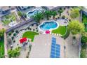 Aerial view of a well-maintained backyard with pool, seating area, lush landscaping, and solar panels at 6731 S 37Th Dr, Phoenix, AZ 85041