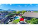 Aerial view showcases a private backyard with pool, patio, manicured landscaping, and mountain views in the distance at 6731 S 37Th Dr, Phoenix, AZ 85041