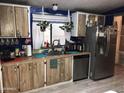 Functional kitchen with stainless steel appliances, wood cabinets, and plenty of counter space at 6960 W Peoria Ave # 156, Peoria, AZ 85345