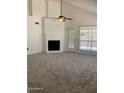 Cozy living room with a white brick fireplace and natural light at 708 N Country Club Way, Chandler, AZ 85226