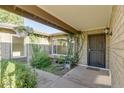 Inviting entryway with lush landscaping and decorative hanging plants, creating a warm welcome at 717 W Manhatton Dr, Tempe, AZ 85282