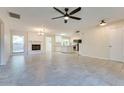 Spacious living room features tile flooring, a cozy fireplace, and seamless flow into the kitchen at 717 W Manhatton Dr, Tempe, AZ 85282