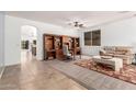 Open-concept living area with a built-in desk and neutral tile flooring at 7413 W Southgate Ave, Phoenix, AZ 85043