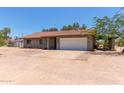 Single story home with a tile roof, 2-car garage, and desert landscaping at 7730 E Culver St, Mesa, AZ 85207