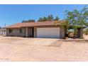 Single story home featuring a tile roof, a two car garage, and xeriscape landscaping at 7730 E Culver St, Mesa, AZ 85207