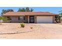 Charming single story home with tile roof, two car garage, and low-maintenance desert landscaping at 7730 E Culver St, Mesa, AZ 85207