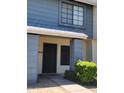 Townhouse entrance featuring a gray-trimmed door and tidy landscaping at 7801 N 44Th Dr # 1036, Glendale, AZ 85301