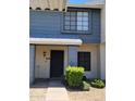 Close-up of charming townhouse entrance with security door and manicured bushes at 7801 N 44Th Dr # 1036, Glendale, AZ 85301