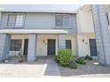 Charming townhouse with blue and white exterior and well-maintained front yard landscaping at 7801 N 44Th Dr # 1036, Glendale, AZ 85301