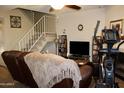 Cozy living room with stairs to the second story and an exercise machine at 7977 W Wacker Rd # 196, Peoria, AZ 85381
