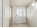 Bright entryway featuring tile flooring and a decorative glass front door with sidelights at 840 N Acacia --, Mesa, AZ 85213