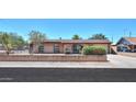 Charming single-story brick home with arched entryway and well-maintained landscaping at 1109 N Walnut Dr, Casa Grande, AZ 85122