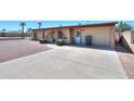 Single-story brick home with well-maintained concrete driveway and tidy landscaping at 1109 N Walnut Dr, Casa Grande, AZ 85122