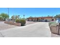 Well-kept single-story home featuring a long driveway and desert landscaping at 1109 N Walnut Dr, Casa Grande, AZ 85122
