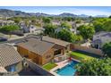 Aerial view of the backyard showing the pool, green space, and surrounding neighborhood at 1506 E Branham Ln, Phoenix, AZ 85042