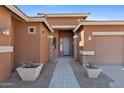 Inviting front entrance with stone pillars, desert landscaping, and paver walkway at 1506 E Branham Ln, Phoenix, AZ 85042