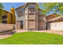 Backyard featuring green lawn, brick patio, and privacy fence, perfect for outdoor entertaining and relaxation at 1515 E South Fork Dr, Phoenix, AZ 85048