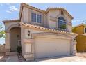 Inviting two-story home with a spacious two-car garage, showcasing its appealing curb presence in a suburban setting at 1515 E South Fork Dr, Phoenix, AZ 85048