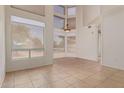 Bright living room boasting high ceilings, large windows and neutral tile flooring, creating an open and airy atmosphere at 1515 E South Fork Dr, Phoenix, AZ 85048