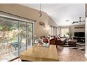 Open-concept home featuring a connected living room and dining area with seamless access to the outdoors at 16833 N 113Th Ave, Surprise, AZ 85378