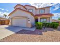 Two-story home with a well-manicured front yard and a welcoming covered porch at 1789 E Desert Breeze Pl, Casa Grande, AZ 85122