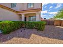 Landscaped front yard featuring a trimmed hedge, decorative rock, and a covered entry porch at 1789 E Desert Breeze Pl, Casa Grande, AZ 85122