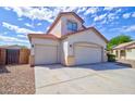 Home featuring a three-car garage, a concrete driveway, and low-maintenance desert landscape at 1789 E Desert Breeze Pl, Casa Grande, AZ 85122