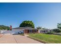 Charming single-story home with a well-maintained front yard, brick facade, and inviting entrance at 1909 E Bethany Home Rd, Phoenix, AZ 85016